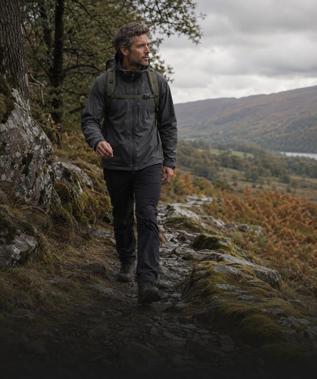 Man hiking a trail with a backpack