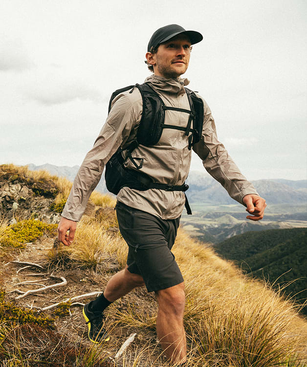 Man hiking a trail with a backpack